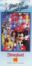 A smiling family of four posing with Mickey Mouse in front of Sleeping Beauty Castle surrounded by colorful Mickey-shaped balloons